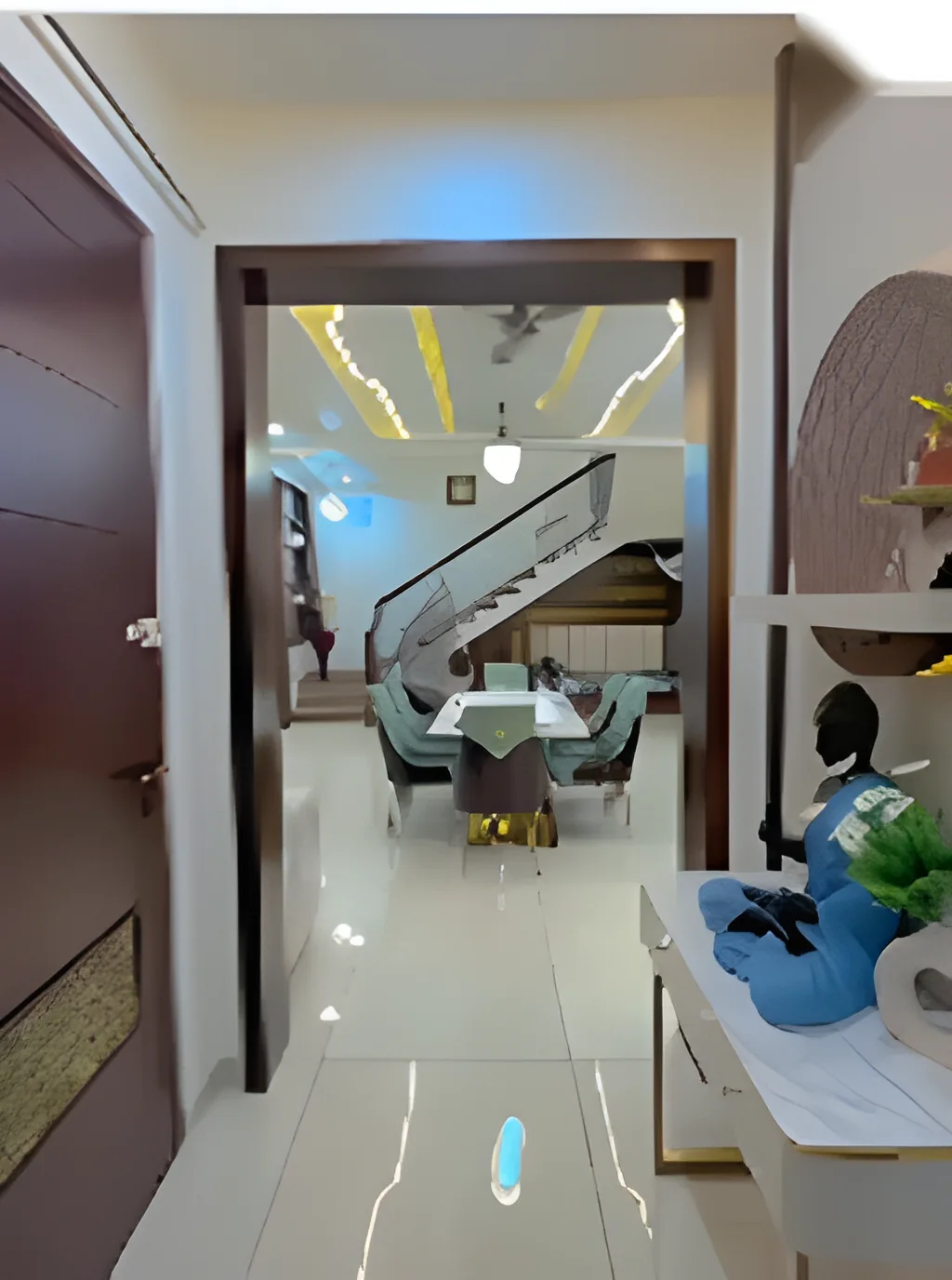 Entrance hall with polished flooring opening onto a dining area under a gold-lit ceiling recess