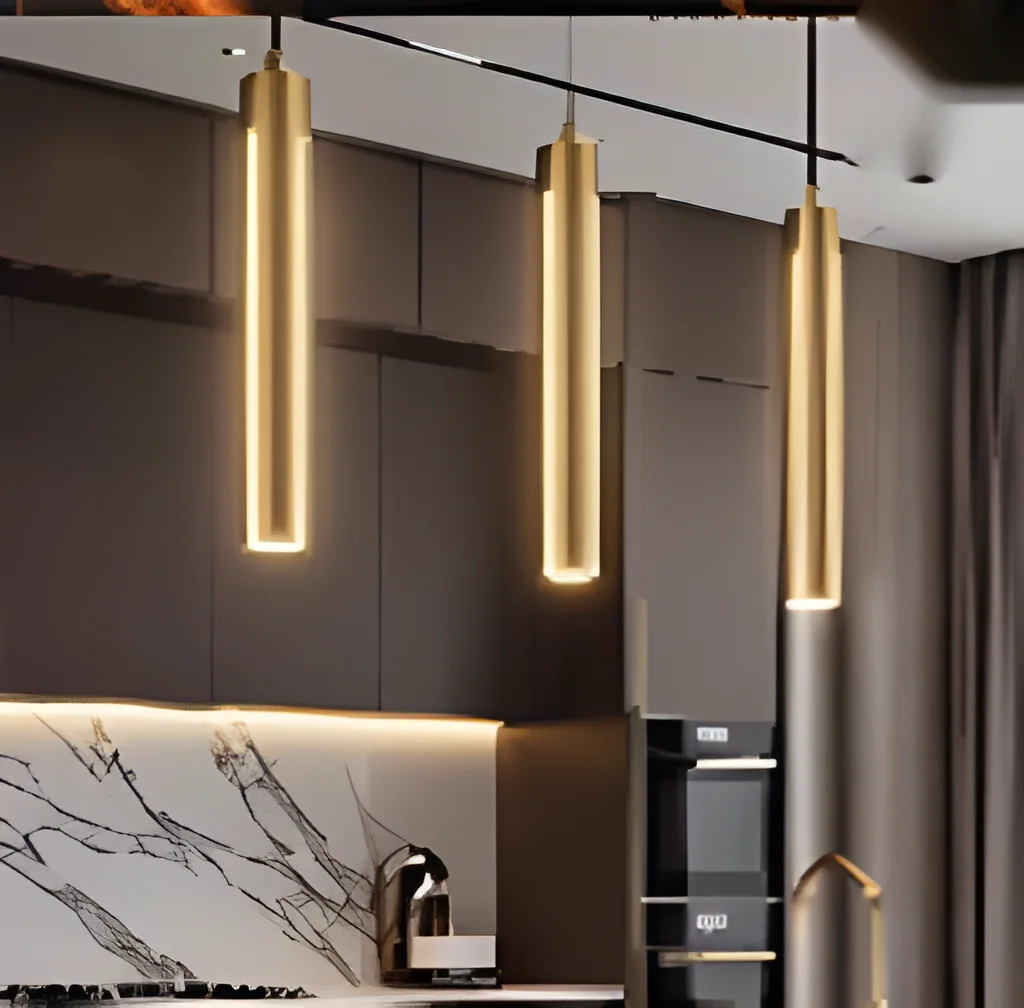 Handleless kitchen in a warm dark finish, lit by three slim brass pendant lights above a marble-look counter