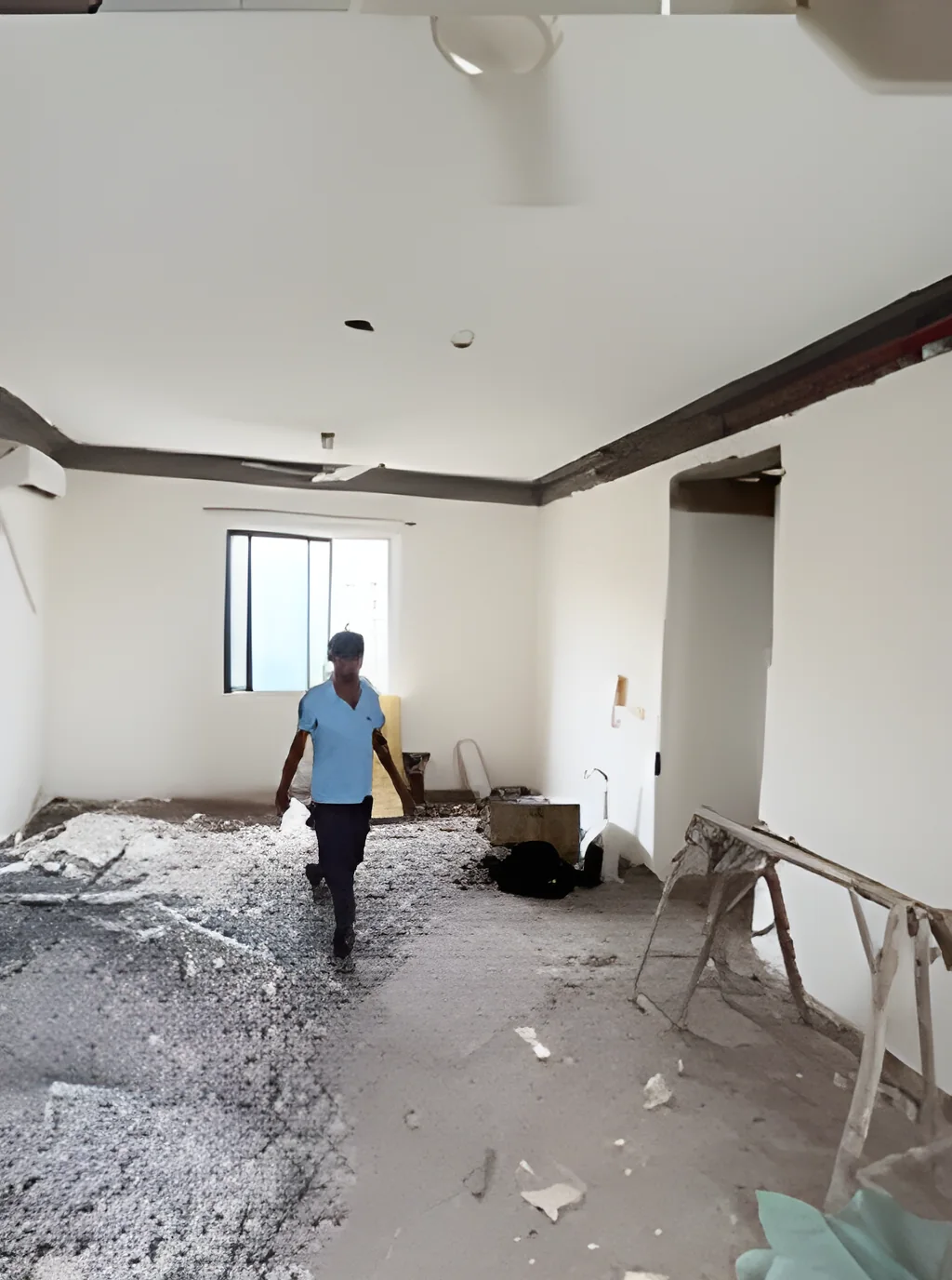 Apartment stripped back to bare structure with a worker on site during the civil stage